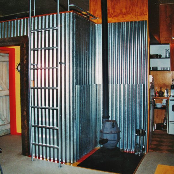 The corrugated iron theme pervades. Potbelly woodburner